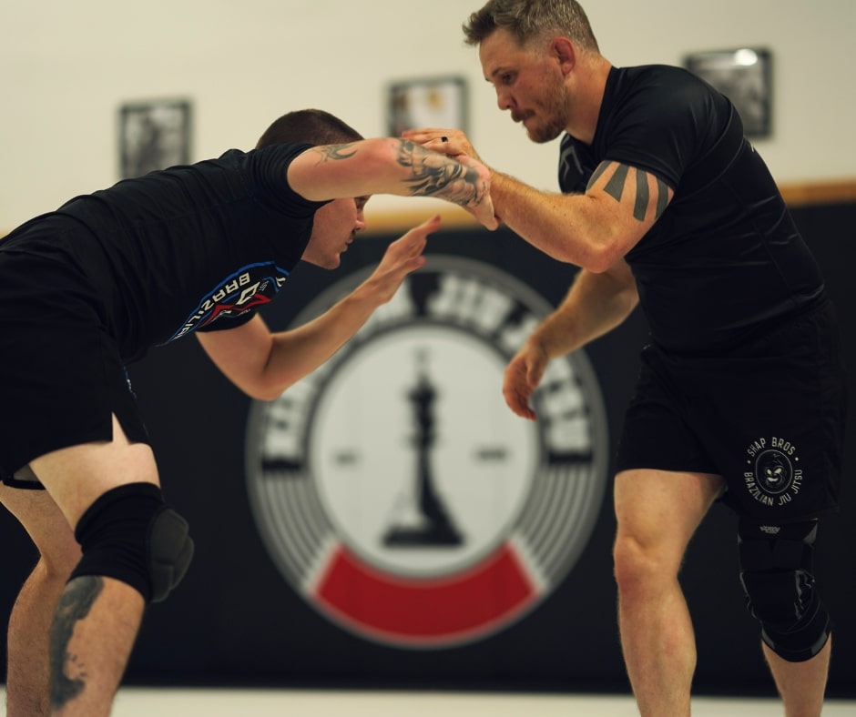 Students practicing Greco-Roman wrestling techniques during a class at Kingdom Jiu-Jitsu Academy in Yukon, Oklahoma.